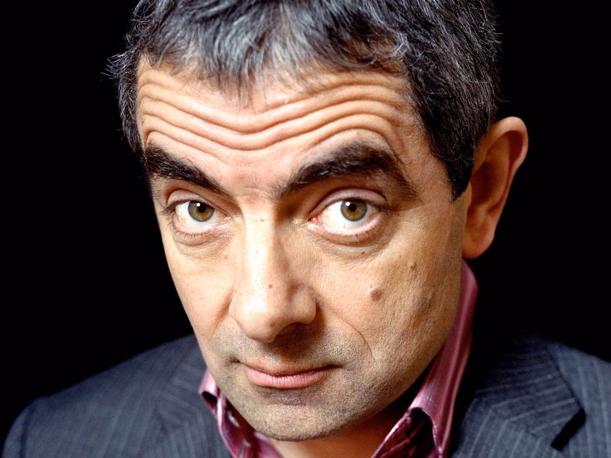 Why did Rowan Atkinson split from his wife?