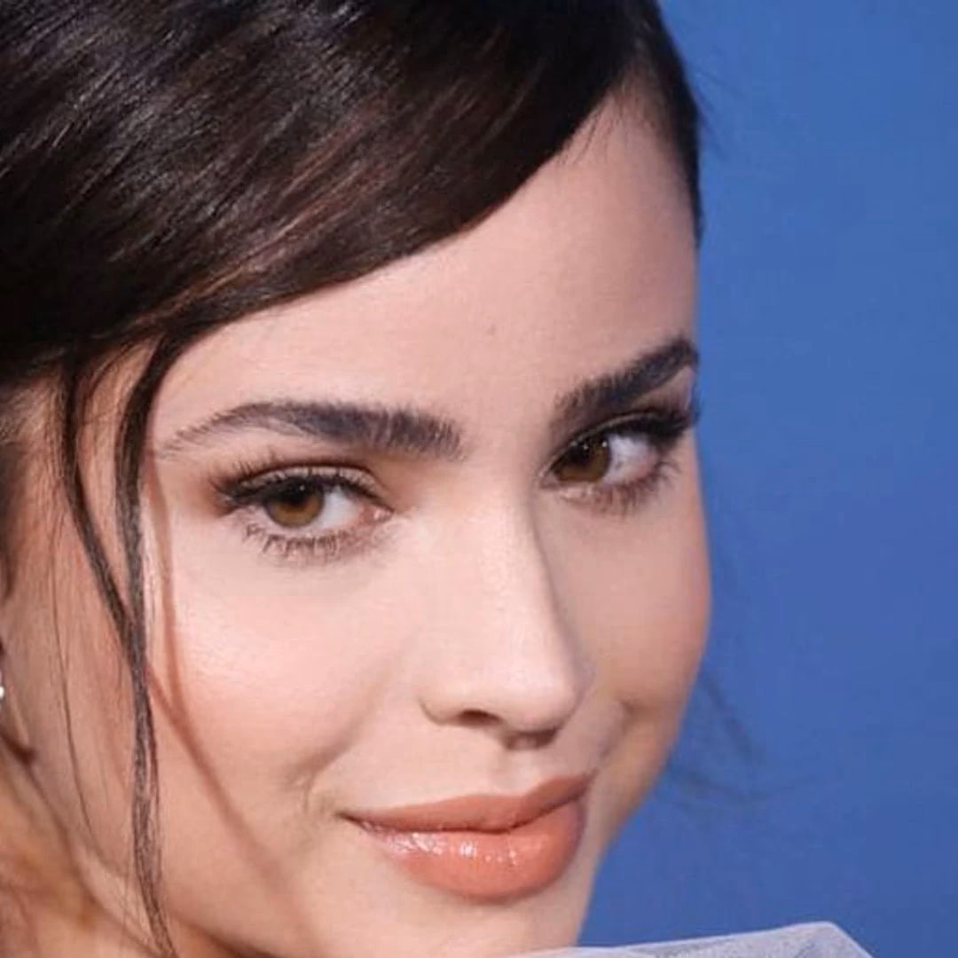 Why is Sofia Carson's hair tucked in?